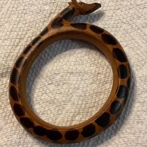 Wooden giraffe bracelet with 9 inches around inside. Never worn and like new.